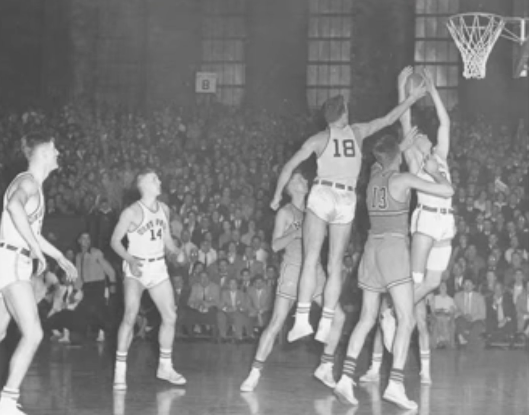 Hannon, No. 18, rising for a rebound before a packed house